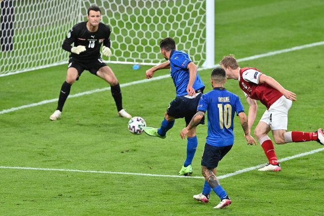 Matteo Pessina scores Italy's second goal past Austria's Daniel Bachmann.