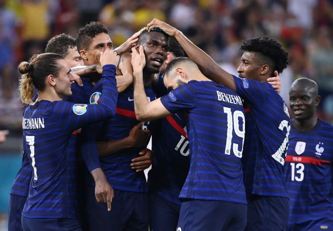 Paul Pogba celebrates with teammates after scoring France's third goal