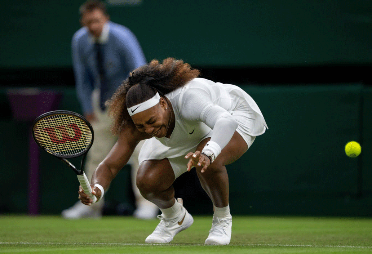 Serena Williams grimaces in pain as she sustains an injury during her first round match