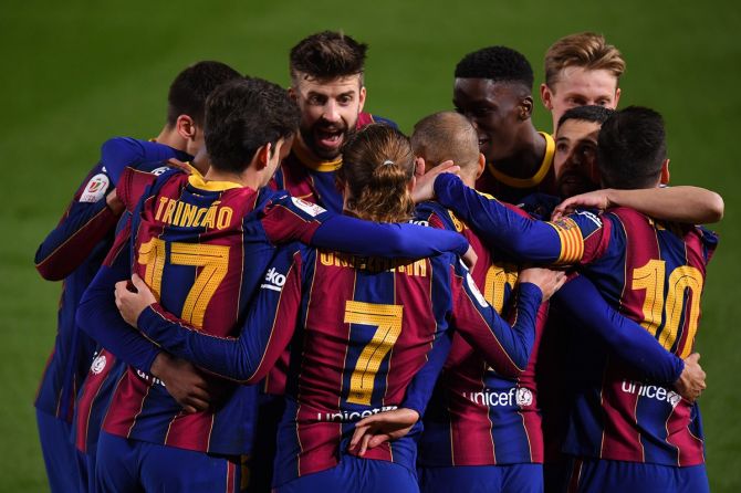 Martin Braithwaite celebrates with Trincao, Antoine Griezmann and Lionel Messi after scoring Barcelona's third goal during the Copa del Rey semi-final second leg match against Sevilla
