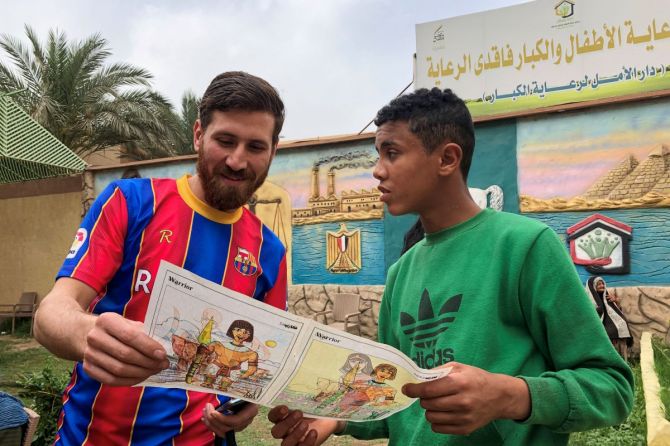 Islam Mohammed Ibrahim Battah is seen with a youth in a club training facility, in Zagazig, north of Cairo, Egypt on Tuesday