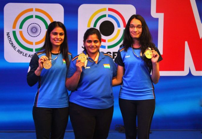 Manu Bhaker, Rahi Sanorbat and Chinky Yadav show off their medals after taking gold in the 25m pistol event at the ISSF World Cup in New Delhi on Thursday