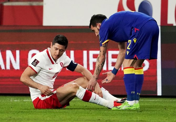 Poland's Robert Lewandowski reacts after sustaining an injury as Andorra's Cristian Martinez looks on during their World Cup qualifier at Polish Army Stadium, Warsaw, Poland on Sunday