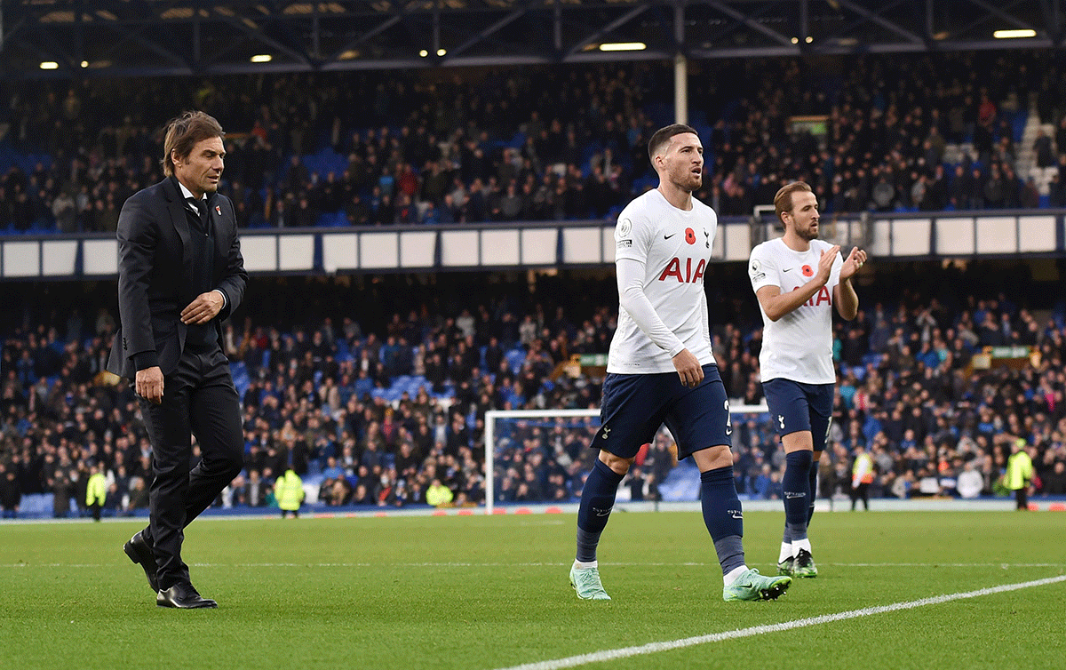 Tottenham Hotspur manager Antonio Conte walks off as Matt Doherty and Harry Kane applaud fans after the match agains Everton at Goodison Park in Liverpool 