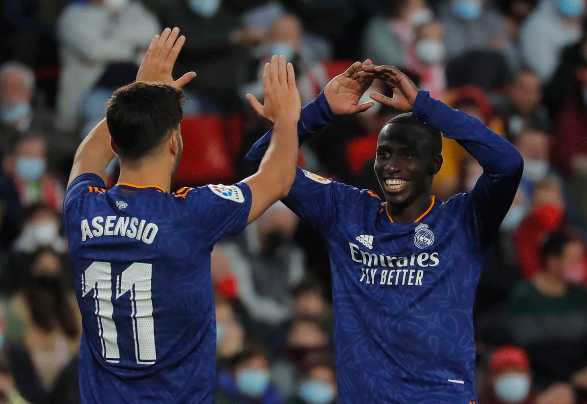 Real Madrid's Ferland Mendy celebrates scoring their fourth goal with Marco Asensio during their La Liga match against Granada at Nuevo Estadio de Los Carmenes, Granada, Spain