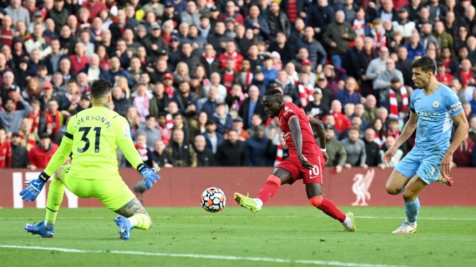 Sadio Mane sends the ball past Ederson to put Liverpool ahead during the Premier League match against Manchester City, at Anfield in Liverpool, on Sunday.