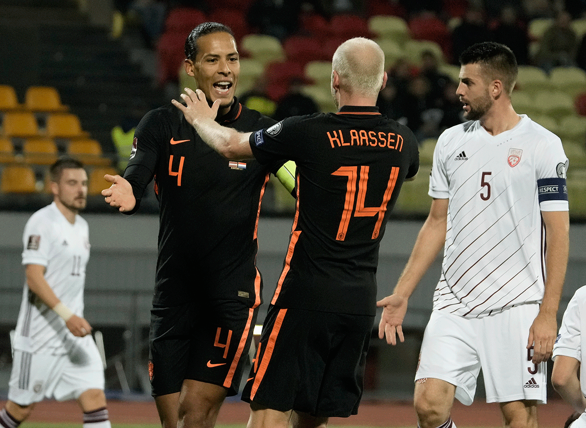 Netherlands' Davy Klaassen celebrates scoring their first goal with Virgil van Dijk as Latvia's Antonijs Cernomordijs reacts at Daugava Stadium, Riga, Latvia