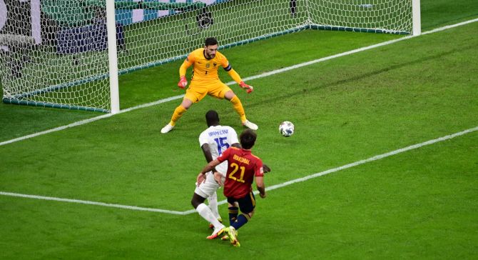 Mikel Oyarzabal sends the ball past France goalkeeper Hugo Lloris to put Spain ahead in the final.