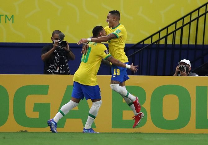 Raphinha celebrates scoring Brazil's second goal with Neymar during the South American World Cup qualifier against Uruguay