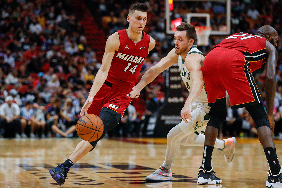 Miami Heat guard Tyler Herro (14) dribbles the ball around Milwaukee Bucks guard Pat Connaughton (24) during the fourth quarter of the game at FTX Arena