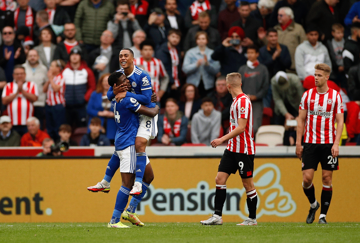 Leicester City's Youri Tielemans celebrates with Kelechi Iheanacho as Brentford players look dejected after the match