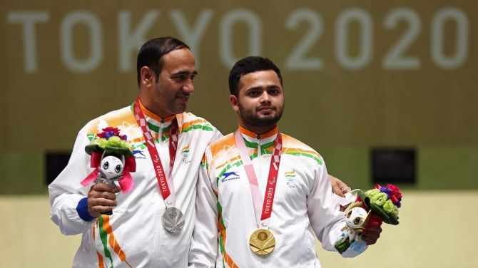 India's Manish Narwal, gold, and compatriot Singhraj Adana, silver, pose with their medals from the P4 Mixed 50m Pistol SH1 event at the Paralympics, in Tokyo, on Saturday. 