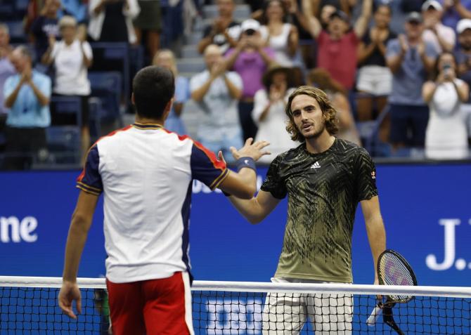 Stefanos Tsitsipas congratulates Carlos Alcaraz after their third round match.