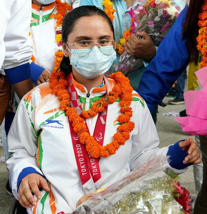 Avani Lekhara, who won a gold and bronze medal in shooting is welcomed after returning from the Tokyo Paralympics 2020 at IGI Airport, in New Delhi, on Monday. 