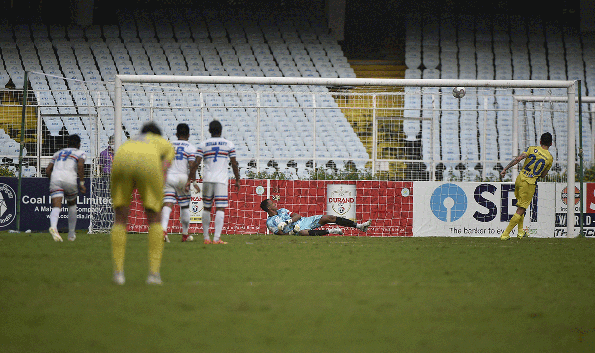 Kerala Blasters' Adrian Luna scores from the spot past the Indian Navy keeper