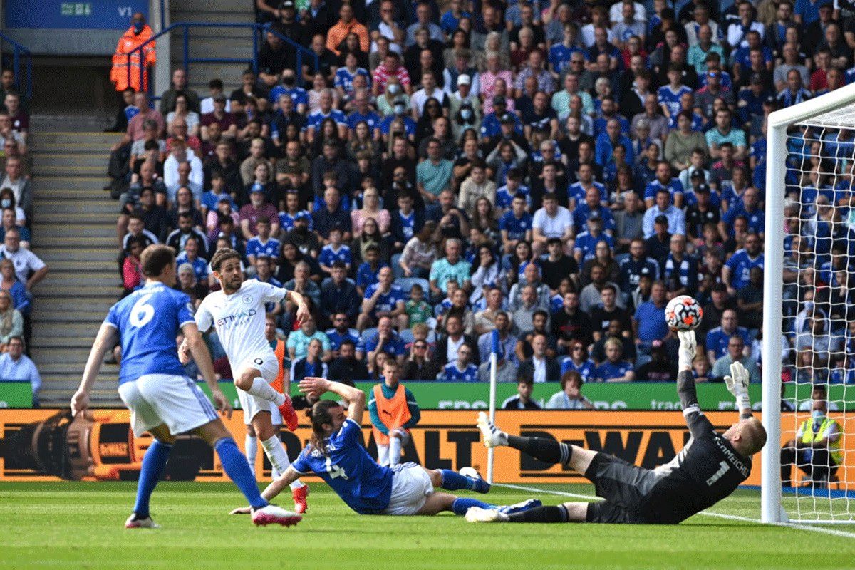 Manchester City's Bernardo Silva scores their first goal past Leicester City's keeper Kasper Schmeichel during their match at The King Power Stadium in Leicester