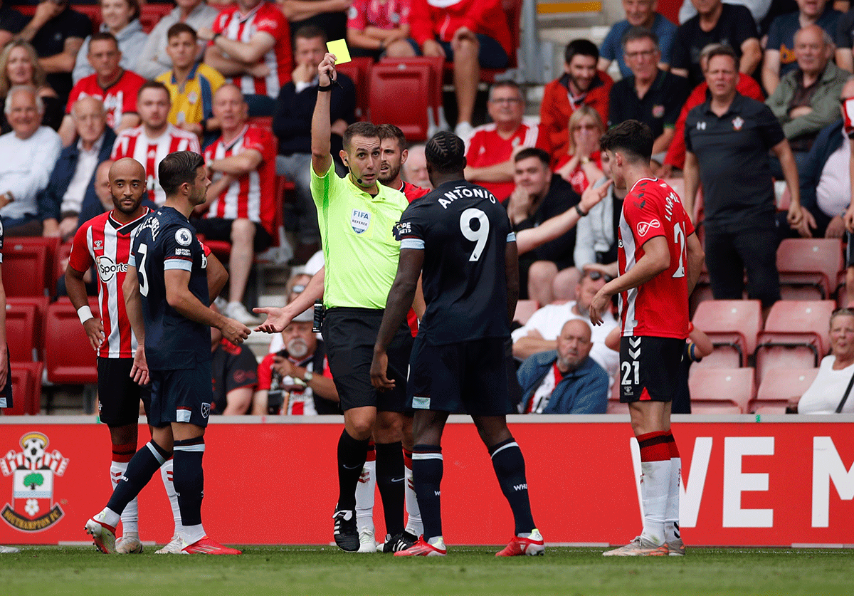 West Ham United's Michail Antonio is shown a yellow card by referee David Coote during the match against Southampton at St Mary's Stadium 
