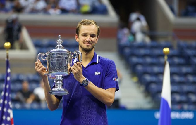Russia's Daniil Medvedev celebrates with the trophy after defeating Serbia's Novak Djokovic in the men's singles final at the US Open on Sunday. 