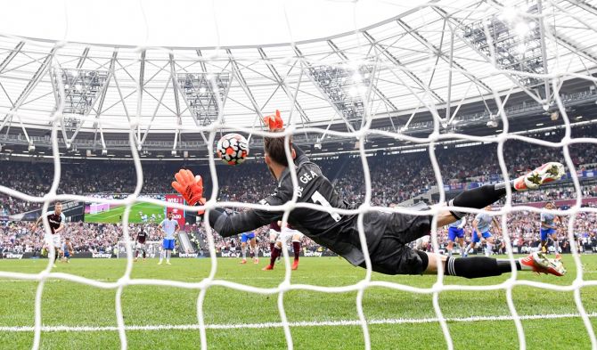 Goalkeeper David De Gea saves a penalty taken by West Ham's Mark Noble in added time to seal victory for Manchester United in the Premier League match, at London Stadium, on Sunday.