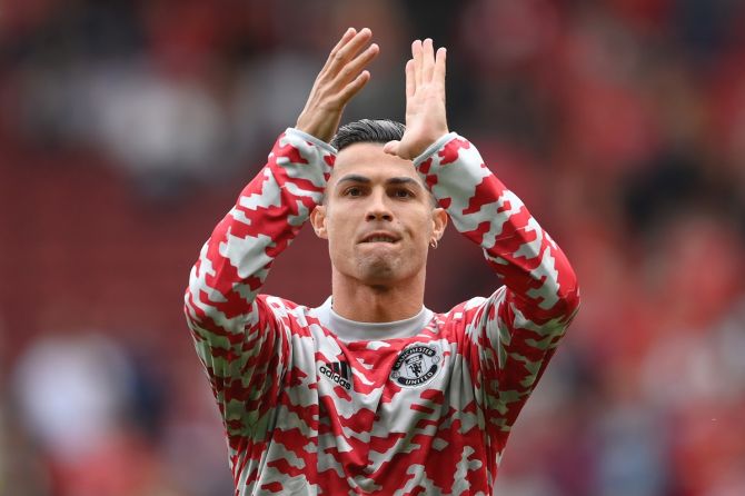 Cristiano Ronaldo acknowledges the applause from fans as he warms up prior to Manchester United's Premier League match against Newcastle United, at Old Trafford in Manchester, on September 11, 2021.