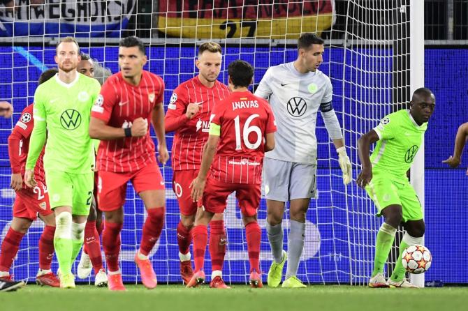 Ivan Rakitic celebrates with teammates after scoring Sevilla's equaliser in the Champions League  Group G match against Wolfsburg, at Volkswagen Arena, in Wolfsburg, Germany.