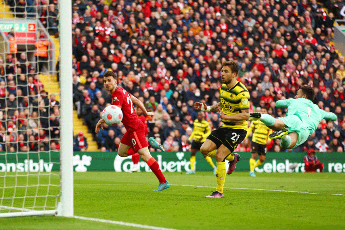 Liverpool's Diogo Jota scores their team's first goal past Watford FC's Kiko Femenia and Ben Foster at Anfield in Liverpool.