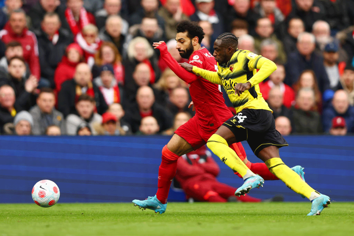 Liverpool's Mohamed Salah battles for possession with Watford FC's Hassane Kamara