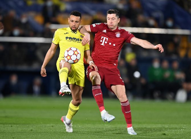 Villarreal's Francis Coquelin battles for possession with Bayern Munich's Robert Lewandowski.