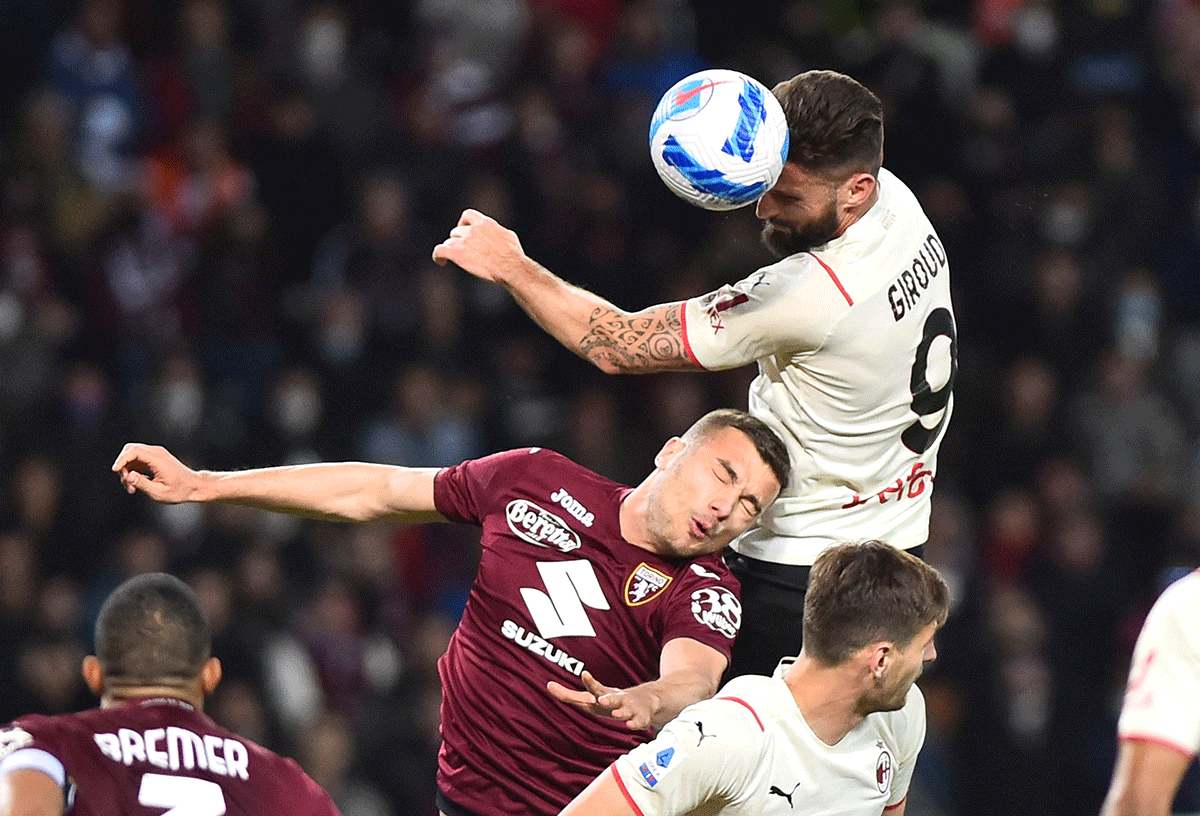 AC Milan's Olivier Giroud in action with Torino's Alessandro Buongiorno during their Serie A match at Stadio Olimpico Grande Torino, Turin, Italy on Sunday