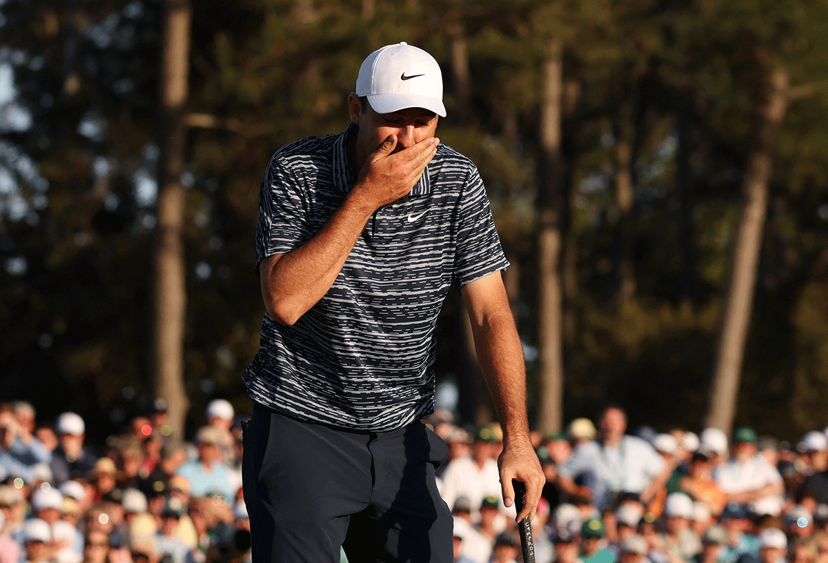 Scottie Scheffler  reacts after he misses a putt in the 18th green before winning The Masters