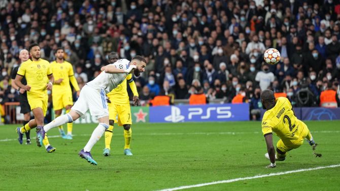 Karim Benzema scores Real Madrid's second goal during the Champions League quarter-final second leg against Chelsea, at Estadio Santiago Bernabeu in Madrid, Spain, on Tuesday.