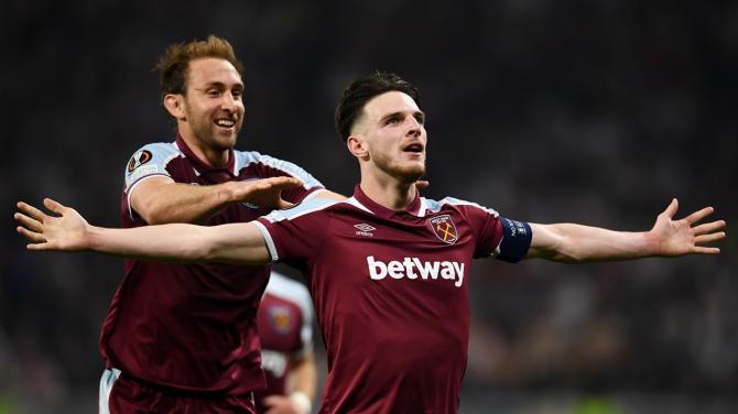 Declan Rice celebrates with teammate Craig Dawson after scoring West Ham United's second goal Olympique Lyon.