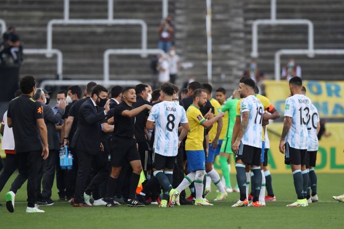 Players and officials engage in discussion on the pitch as play is interrupted after Brazilian health officials object to the participation of three Argentina players, saying they say broke quarantine rules during the South American World Cup qualifier at Arena Corinthians, in Sao Paulo, Brazil, September 5, 2021.
