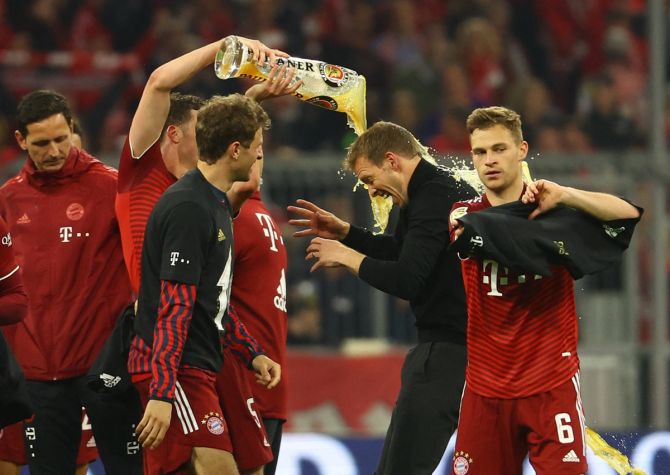 Bayern Munich coach Julian Nagelsmann celebrates with his players after beating Borussia Dortmund and winning the Bundesliga, at Allianz Arena, in Munich, Germany, on Saturday.