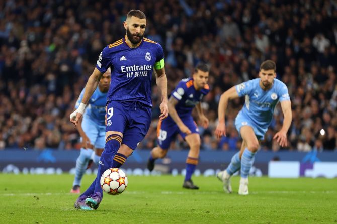 Karim Benzema scores Real Madrid's third goal with a 'Panenka' penalty during the UEFA Champions League semi-final first leg against Manchester City, at Etihad Stadium in Manchester, England, on Tuesday.