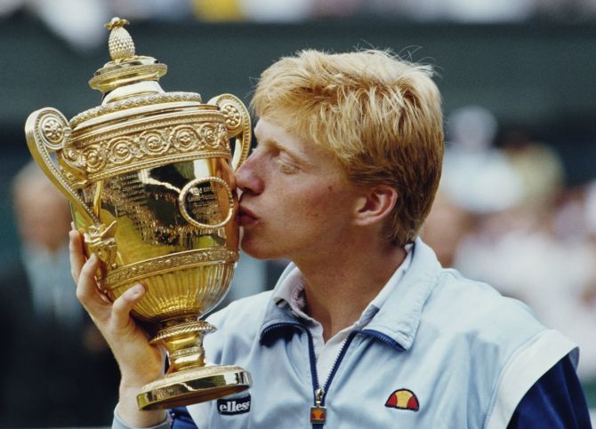Boris Becker kisses the Gentlemen's Singles Trophy in celebration of his victory over Kevin Curren in the men's singles final at the Wimbledon Lawn Tennis Championships on July 7, 1985. It was the German's first career Grand Slam title and his first at Wimbledon.