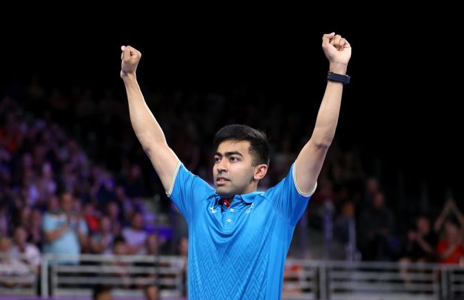 Harmeet Desai celebrates victory over Singapore's Zhe Yu Clarence Chew in the third singles to seal the men's team Table Tennis gold medal for India at the Commonwealth Games on Tuesday.