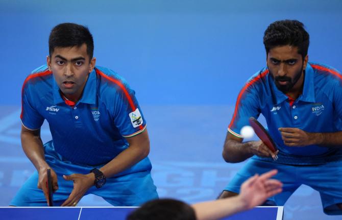 Harmeet Desai and Sathiyan Gnanasekaran in action during their doubles match against Singapore's Yong Izaac Quek and Yew En Koen Pang.