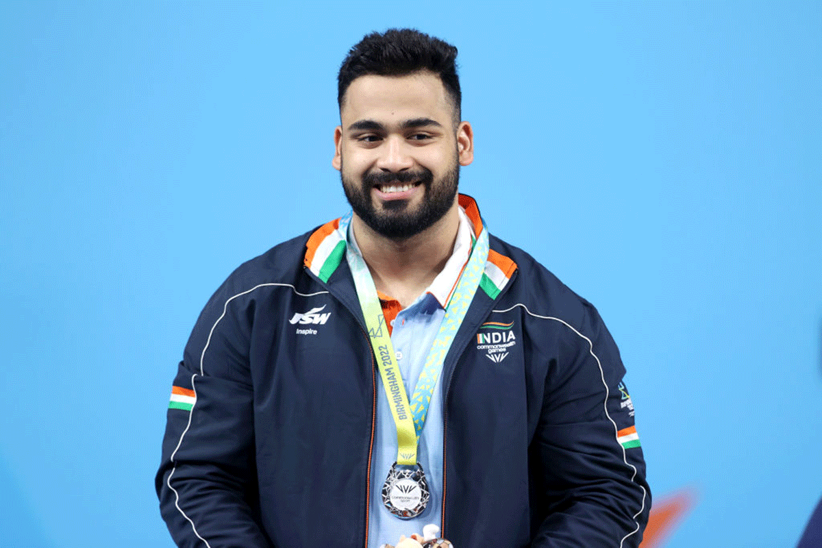 Silver Medalist India's Vikas Thakur celebrates during the Men's Weightlifting 96kg - Final medal ceremony on day five of the Birmingham 2022 Commonwealth Games at NEC Arena in Birmingham on Tuesday