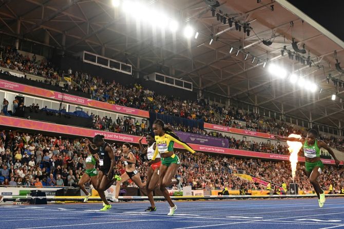 Elaine Thompson-Herah breasts the tape ahead of Saint Lucia's Julien Alfred and England's Daryll Neita in the women's 100m final.