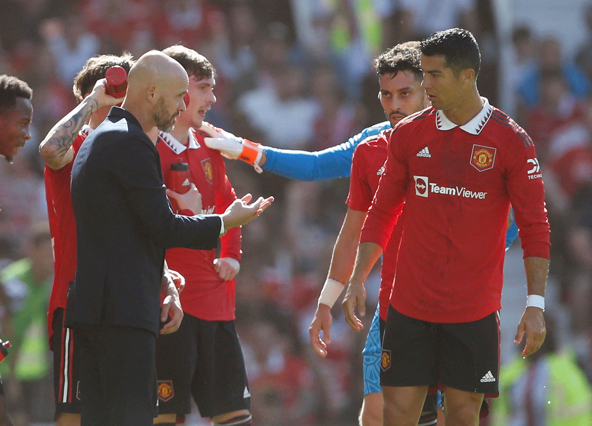 Manchester United manager Erik ten Hag speaks with Manchester United's Cristiano Ronaldo. Ronaldo said Manchester United did not support him when his daughter was taken to hospital in July. He said the club doubted him and showed a lack of empathy when he did not arrive on time for pre-season training.