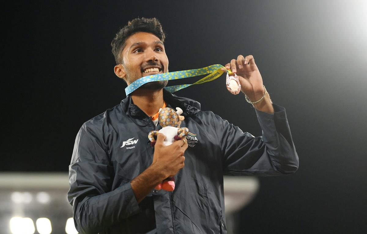 Tejaswin Shankar poses for a photo with his bronze medal after the medal ceremony.