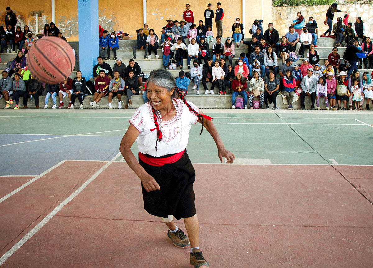 Andrea Garcia Lopez, 71, nicknamed "Granny Jordan" by TikTok users, plays basketball during an exhibition game in San Esteban Atatlahuca, Oaxaca, Mexico, on Wednesday, August 3, 2022