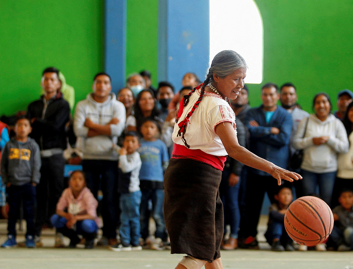 Andrea Garcia Lopez, 71, nicknamed "Granny Jordan" by TikTok users, plays basketball during an exhibition game in San Esteban Atatlahuca, Oaxaca, Mexico