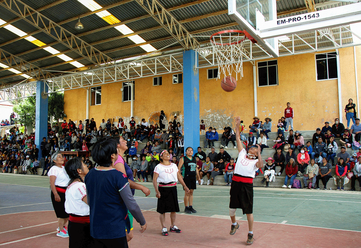 Andrea Garcia Lopez, 71, nicknamed "Granny Jordan" by TikTok users, plays basketball during an exhibition game in San Esteban Atatlahuca, Oaxaca, Mexico