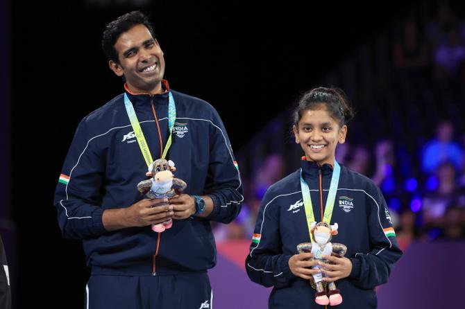 Achanta Sharath Kamal and Sreeja Akula celebrate on the podium after winning the Commonwealth Games Mixed doubles Table Tennis gold on Sunday