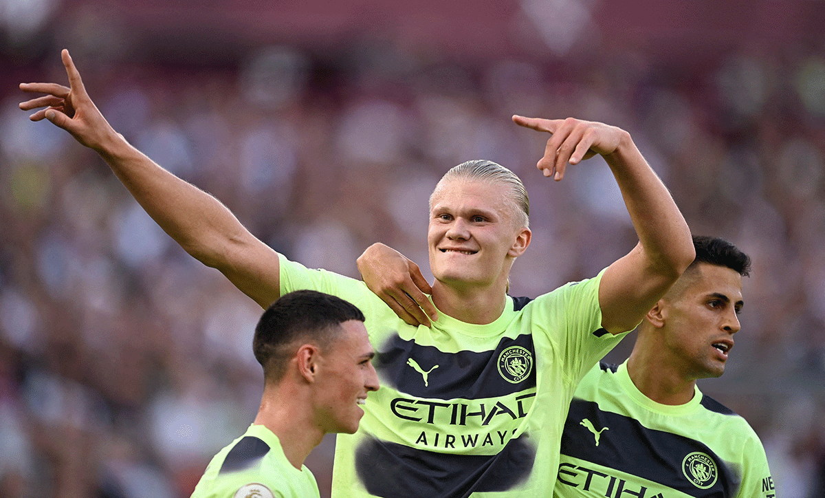 Manchester City's Erling Braut Haaland celebrates with Phil Foden and Joao Cancelo on scoring their second goal against West Ham United at London Stadium in London