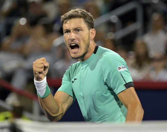 Spain's Pablo Carreno Busta gestures after winning a point during his semi-final against Great Britain's Daniel Evans.