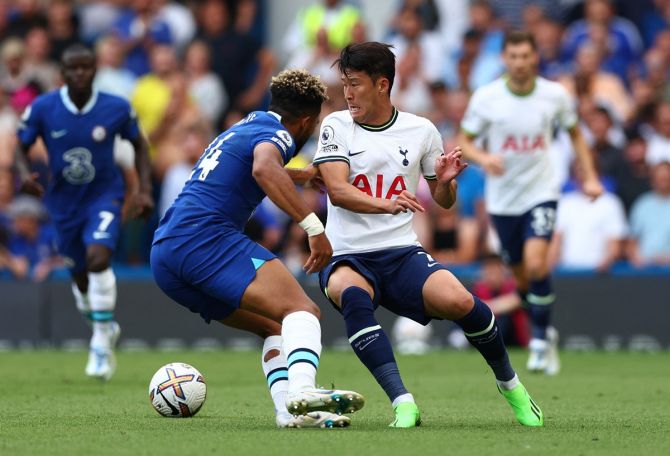 Tottenham Hotspur's Son Heung-min is checked in his stride by  Chelsea's Reece James during the Premier League match at Stamford Bridge, London, on August 14.