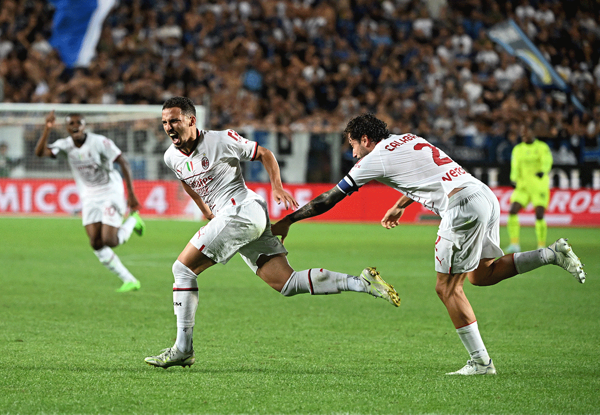 AC Milan's Ismael Bennacer celebrates with Davide Calabria as he scores the first goal against Atalanta during their La Liga match at Stadio Atleti Azzurri, Bergamo, Italy. 